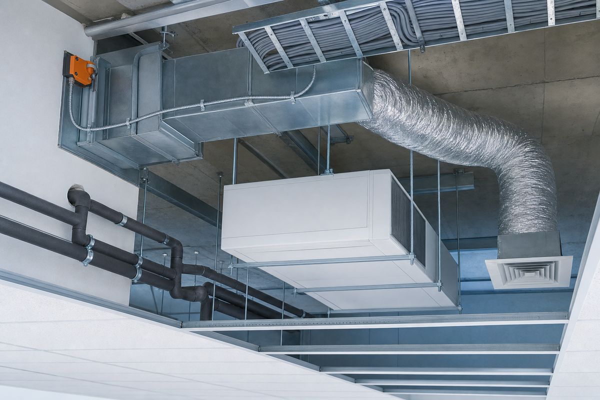 Ductwork, a fan coil unit and cable containment above an open suspended ceiling