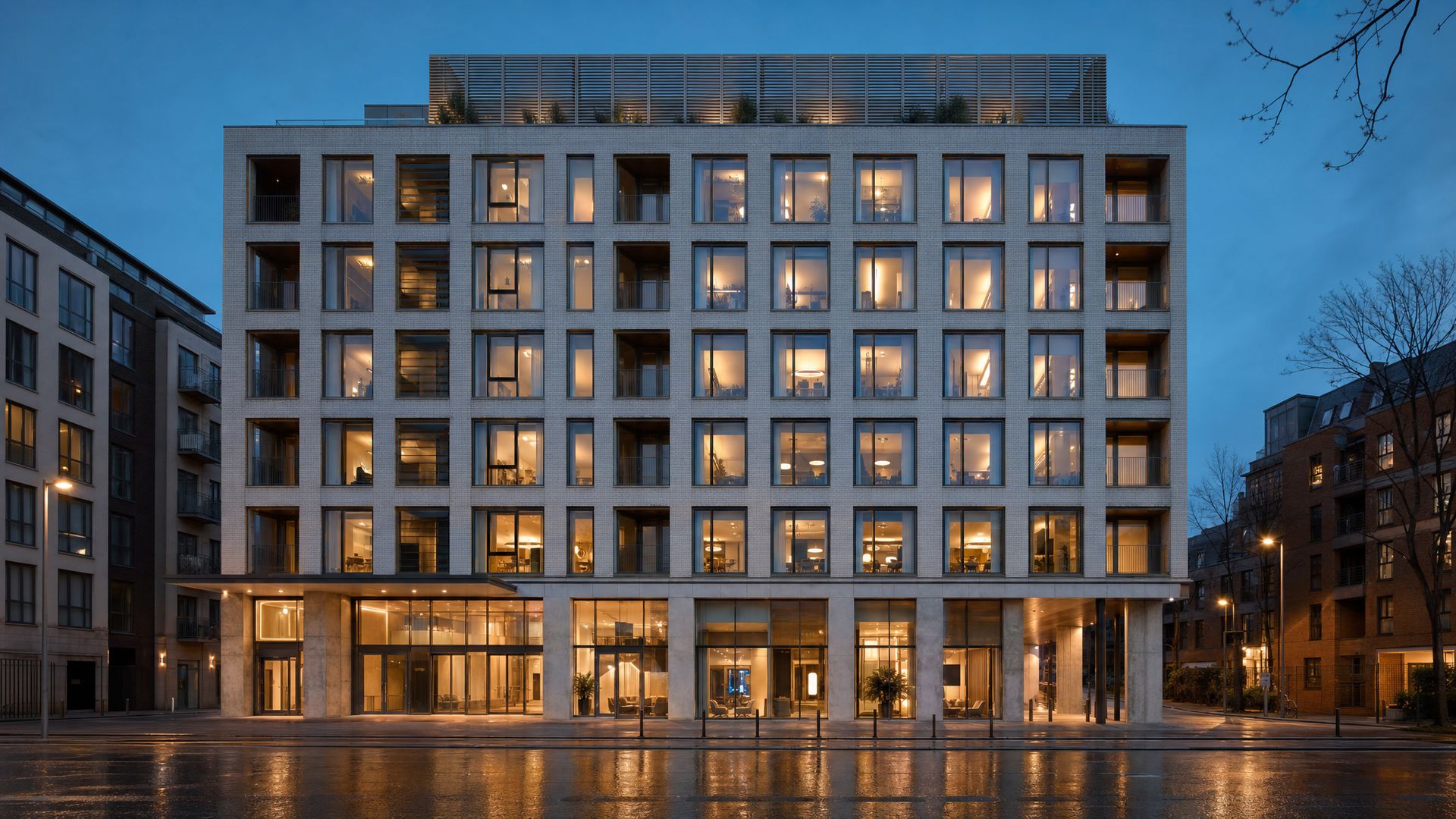 A modern Dublin office and apartment building lit at dusk