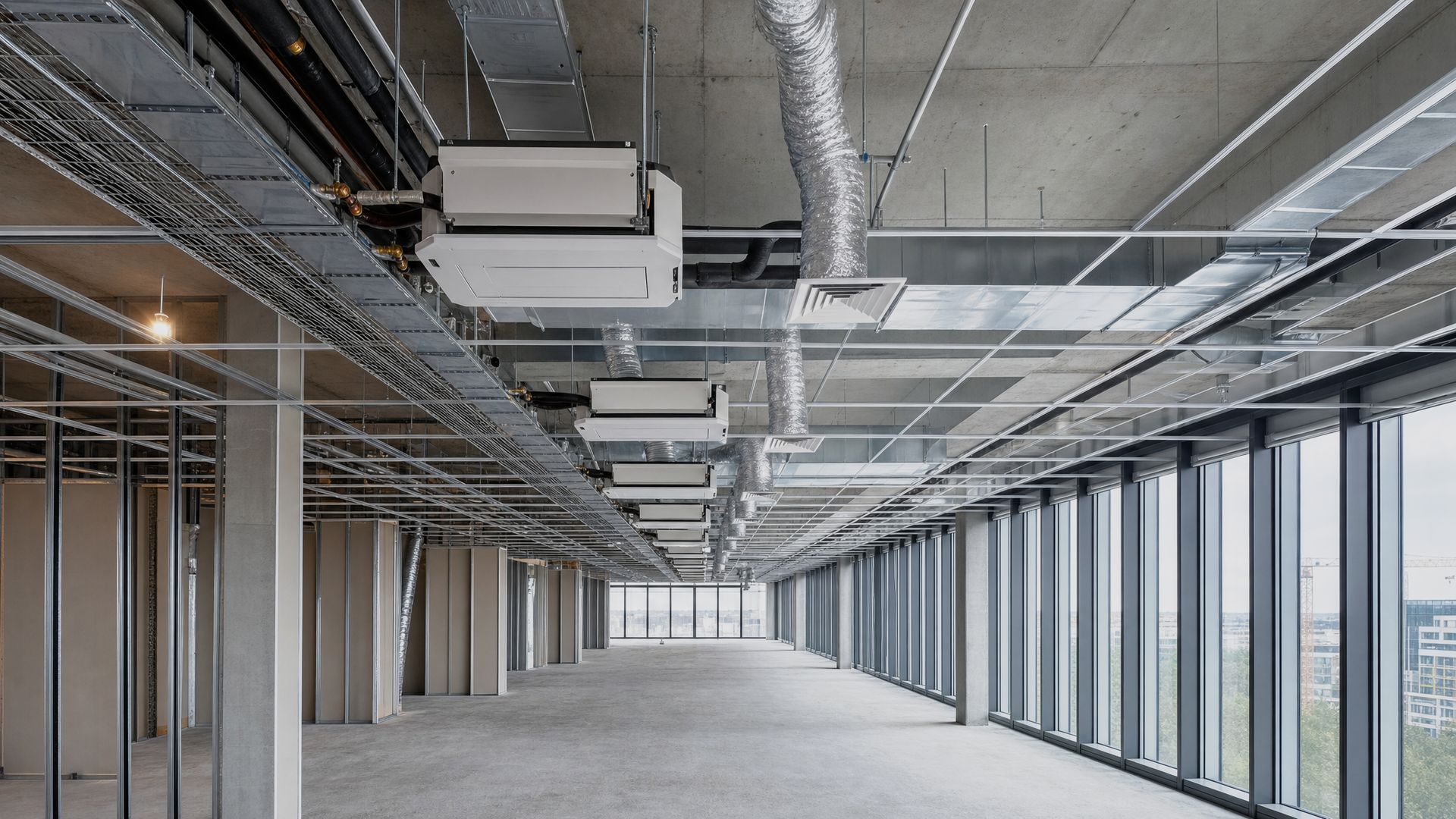 Ductwork and fan coil units above an open plan office floor during fit out
